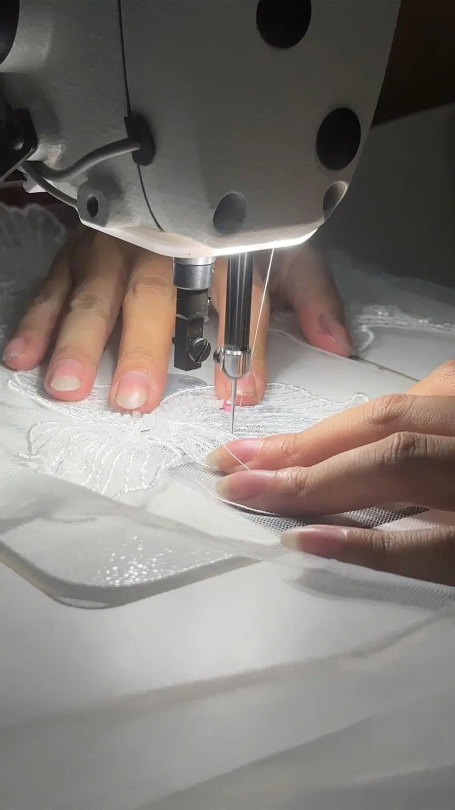 Bridal lace being sewn in the VI Dressmakers atelier before lining and coverage review