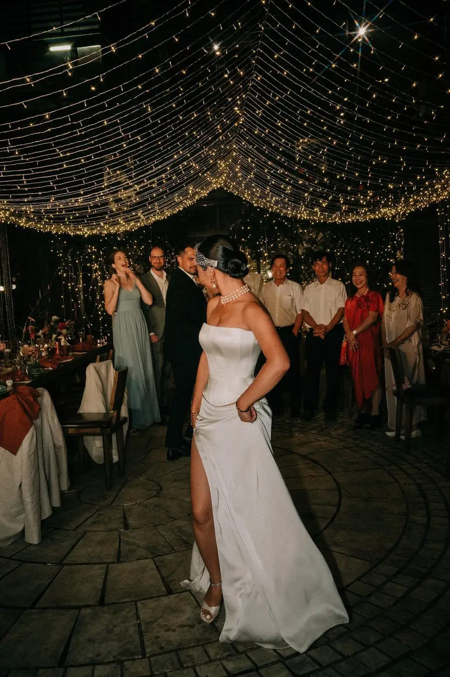 Bride in a custom ivory satin corset wedding dress by VI Dressmakers