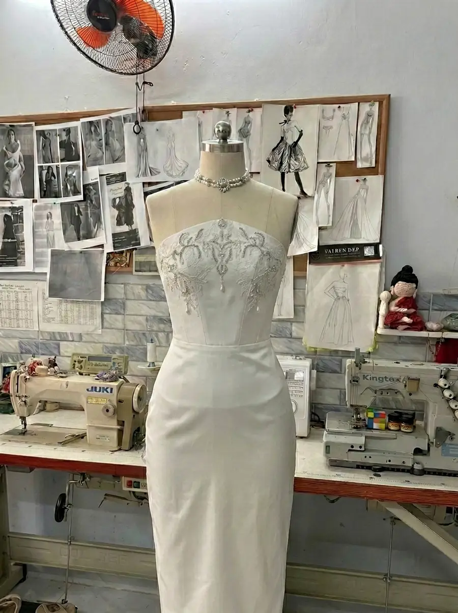 VI Dressmakers atelier — Sofia's crystal-embroidered strapless column on the dress form during production