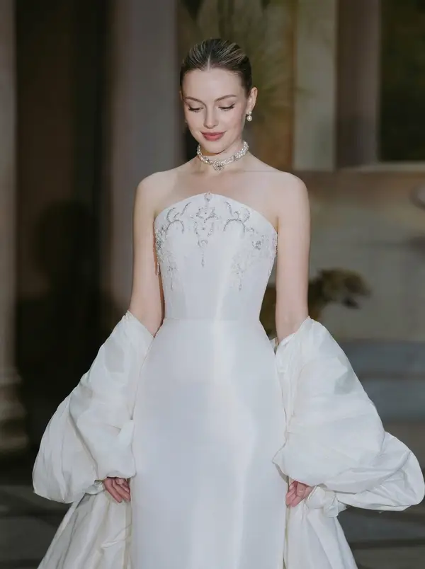 Design direction A — strapless embroidered bodice with voluminous detachable puff sleeves, inspiration reference